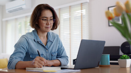 Busy asia smart people or latin sme owner sit on desk table at home enjoy read e-mail on digital...