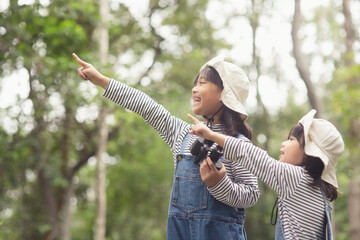 happy Asian girl getting ready for the journey with binoculars.