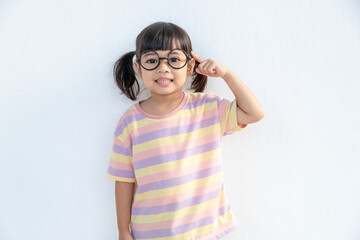 Naklejka premium funny Asian child girl wearing glasses on a white background