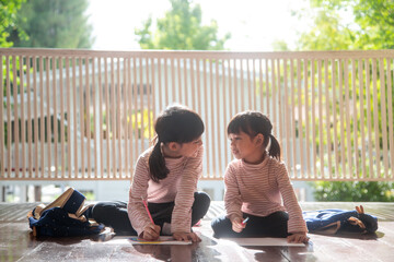 Two Asian Children Doing Homework Together at home