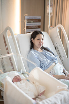Baby and mother in hospital after giving birth (focus mom)