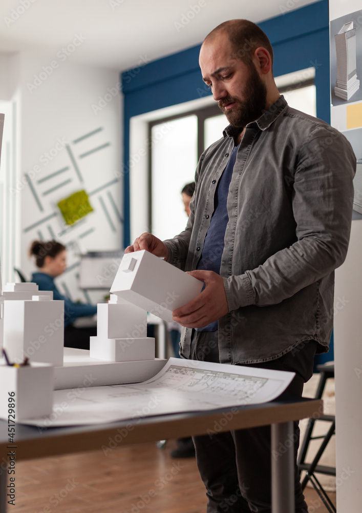 Poster architecture expert person looking at maquette building model design plan. engineer manager working 