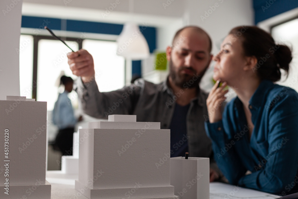 Poster working architect colleagues discussing layout project to design building model maquette. profession
