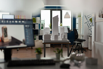 Empty architectural room for design and modern computer with blueprint plan building model maquette. Workplace for professional architect occupation with business equipment desk board