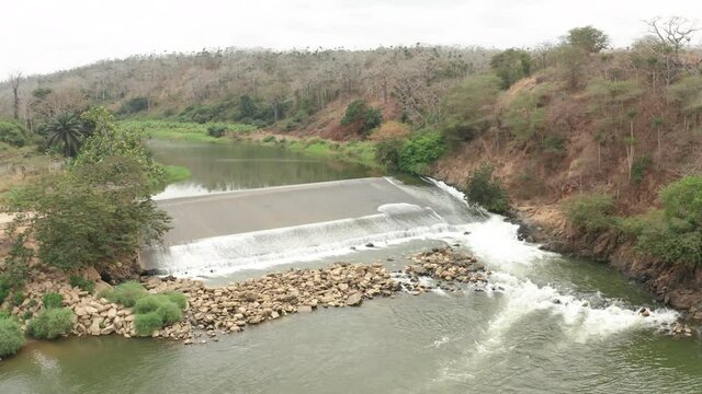 tilt down over a river, dam on a river in Angola, Africa