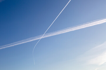 Two intersecting tracks from planes in the sky