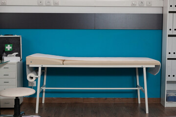 Empty professional cabinet with bed for consultations used by doctor and patients. Nobody in hospital room but medical furniture used for healthcare examination at modern clinic