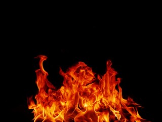 Fototapeta premium Flame meat that burns from a furnace or from cooking. dangerous feeling abstract black background .Suitable for banners or advertisements