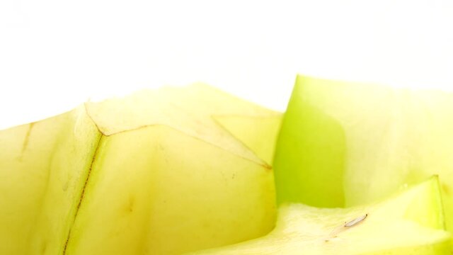 4K Organic star fruit carambola or star apple ( starfruit ) close-up rotates on a white background