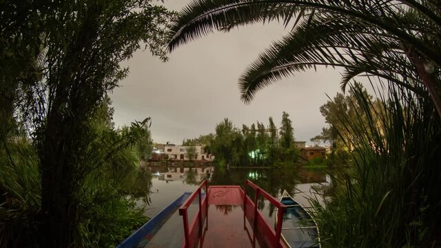 Time lapse in Xochimilco with trajineras at 4am in a cloudy night