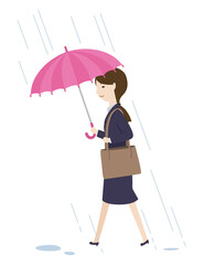 本降りの雨の中で傘を差して歩く女性社員
