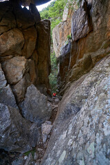 Climb a mountain between large rocks