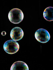 colored soap bubbles on black background