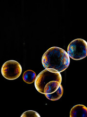 colored soap bubbles on black background