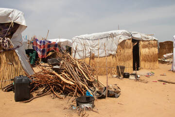 Refugee camp (IDP - Internal displaced persons) taking refuge from armed conflict between opposition groups and government. Very poor living conditions, lack of water, hygiene, shelter and food - obrazy, fototapety, plakaty