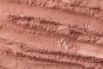 Texture of dry red cosmetic clay with brushstroke top view. Abstract background of pink cosmetic...