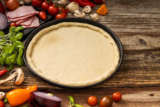 Raw delicious pizza with vegetables and green persley