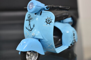 Vintage Cars & Scooter Toys on Reflective Surface
