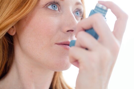 Woman using inhaler