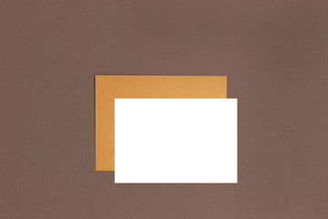 Envelope and empty paper sheet mockup. Letter on a brown background.