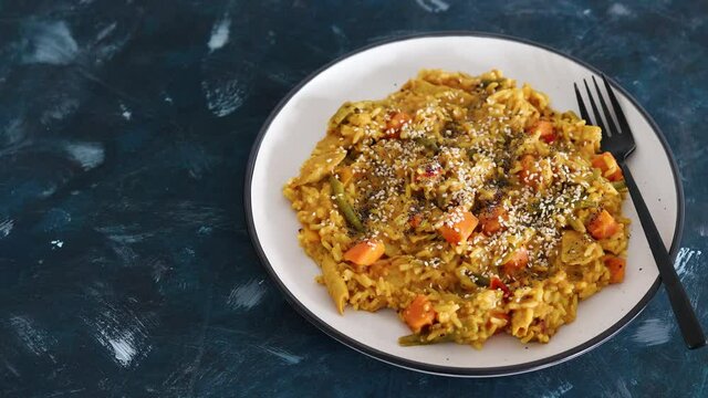 vegan curry rice with sweet potatoes beans and bell peppers and plantbased chicken, healthy plant-based food