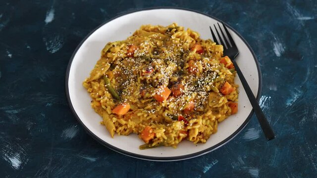 vegan curry rice with sweet potatoes beans and bell peppers and plantbased chicken, healthy plant-based food