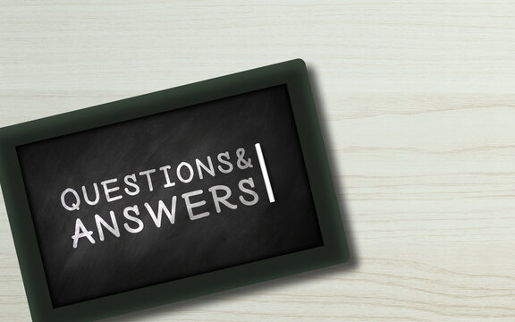 Question Answerers Written in Small chalkboard. hand Written Q&A in blackboard on Wooden background  with Copy space. Business help and support concept  