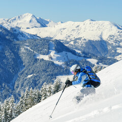 Fototapeta na wymiar Freeskierin befährt perfekt ausgerüstet einen unverspurten Tiefschneehang in Tirol