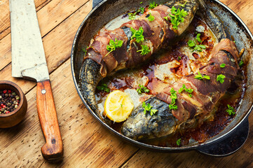Baked fish wrapped in bacon