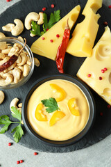 Tray with cheese sauce and snacks, top view