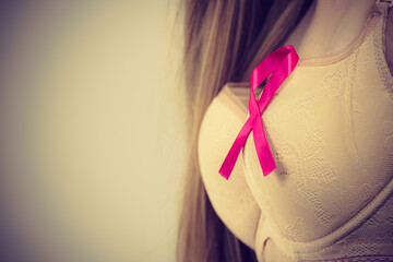 Woman chest in bra, pink cancer ribbon