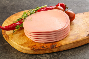 Sliced pork sausages stack over board