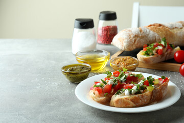 Concept of cooking bruschetta snacks on gray textured table