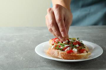 Concept of cooking bruschetta snacks on gray textured table