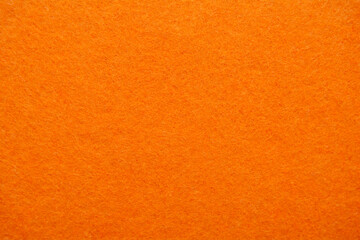 Bright orange felt, textured fabric background. Material surface. Copy space