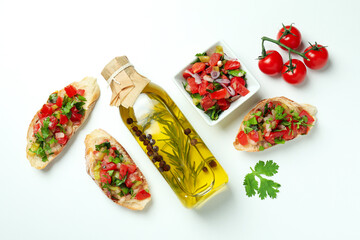 Delicious italian snacks bruschetta and ingredients on white background