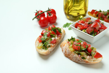 Delicious italian snacks bruschetta and ingredients on white background