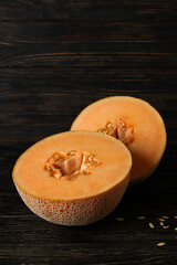 Ripe melon halves on rustic wooden table