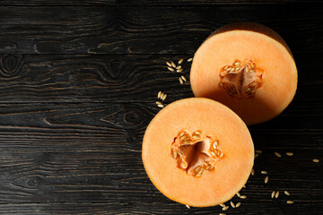 Ripe melon halves on rustic wooden table