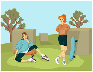 Two girls in the park in sweatshirts in a sporty style on skateboards are resting.
