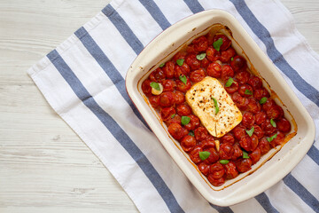 Fototapeta na wymiar Homemade Baked Feta Tomato Pasta in a baking dish, overhead view. Flat lay, top view, from above. Copy space.