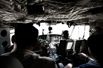 Military helicopter cockpit with pilots and passengers. - 451752846