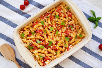 Homemade Baked Feta Tomato Pasta in a baking dish, top view. Flat lay, overhead, from above.