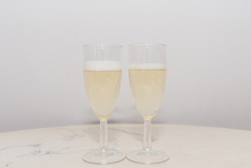 two champagne glass foam on a table for valentine or honeymoon concept.Indoors shot.
