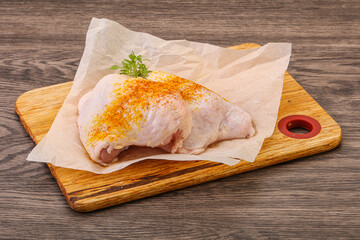 Raw chicken thigh with spices