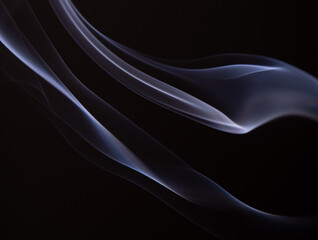 Soft smoke lines using natural light, with a black background