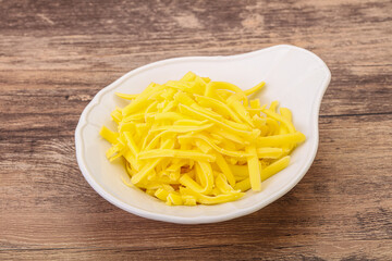 Shredded yellow cheese in the bowl