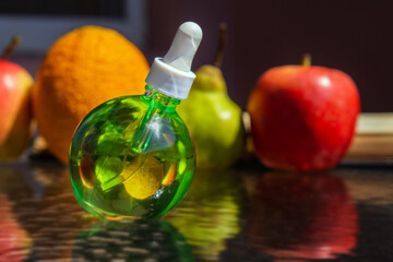 Round bottle with green skin care oil.