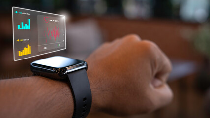 Close up smart watch on the wrist of a man who is exercising tells his heart rate. Step count and...