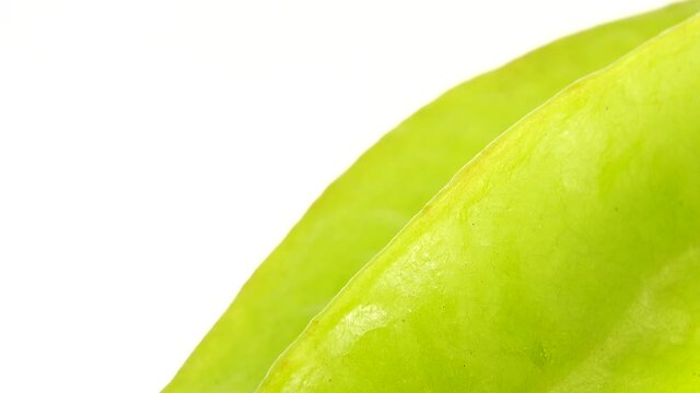 4K Organic star fruit carambola or star apple ( starfruit ) close-up rotates on a white background